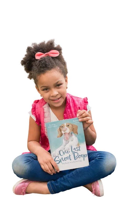 girl holding the book 'one last snoot boop' by John Graff